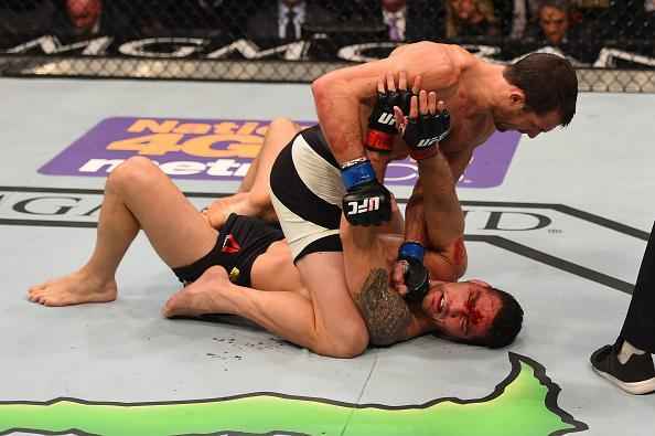 Luke Rockhold (luvas azuis) venceu Chris Weidman por nocaute técnico no quarto round e conquistou o cinturão dos médios do UFC