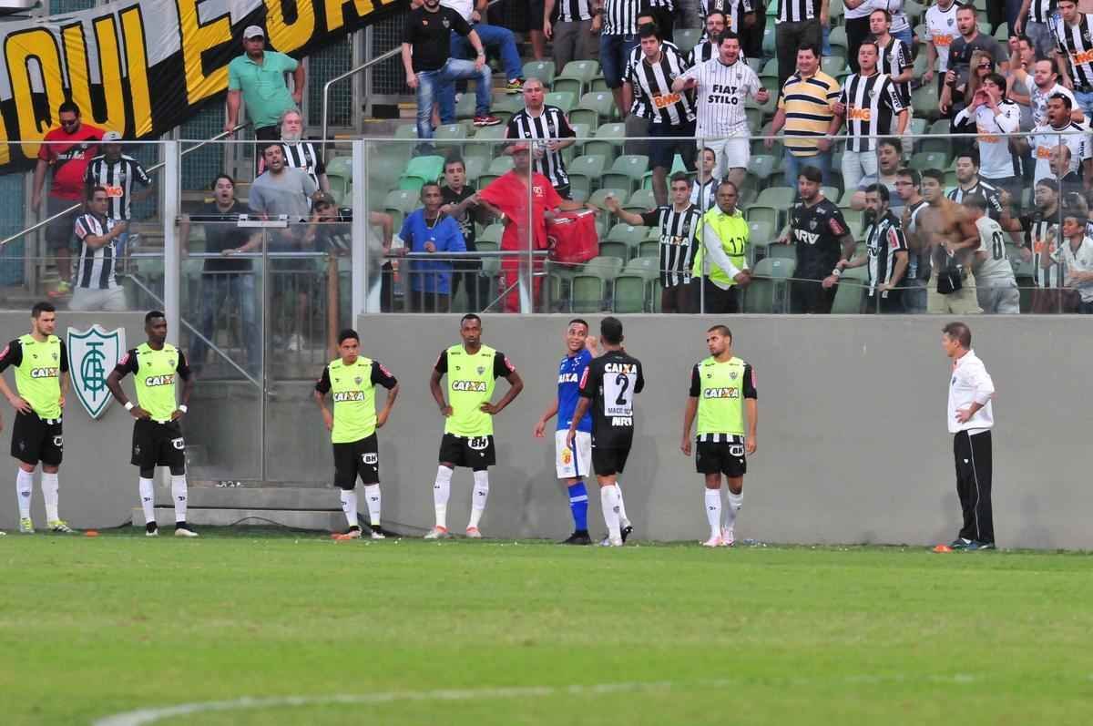 Instantes depois, Fred tenta esconder chinelo atirado pela torcida do Atltico e se desentende com Henrique