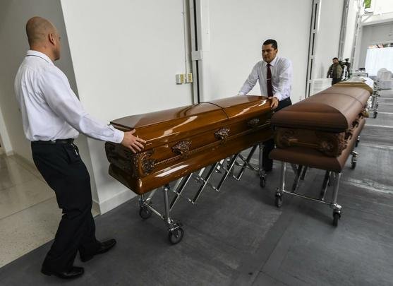 Funcionários da funerária preparam os caixões dos jogadores e comissão técnica da Chapecoense