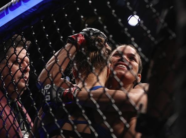 Amanda Nunes (luvas vermelhas) venceu Ronda Rousey por nocaute tcnico em 48 segundos e manteve o cinturo dos galos