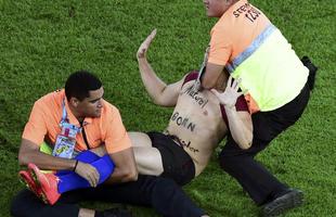 Com dizeres 'brincalhão por natureza' na barriga, torcedor invade gramado do Maracanã durante a final da Copa do Mundo, entre Alemanha e Argentina, e dá trabalho à segurança até ser retirado 